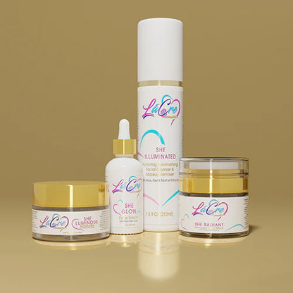 A collection of skincare products with white and gold packaging on a beige background.